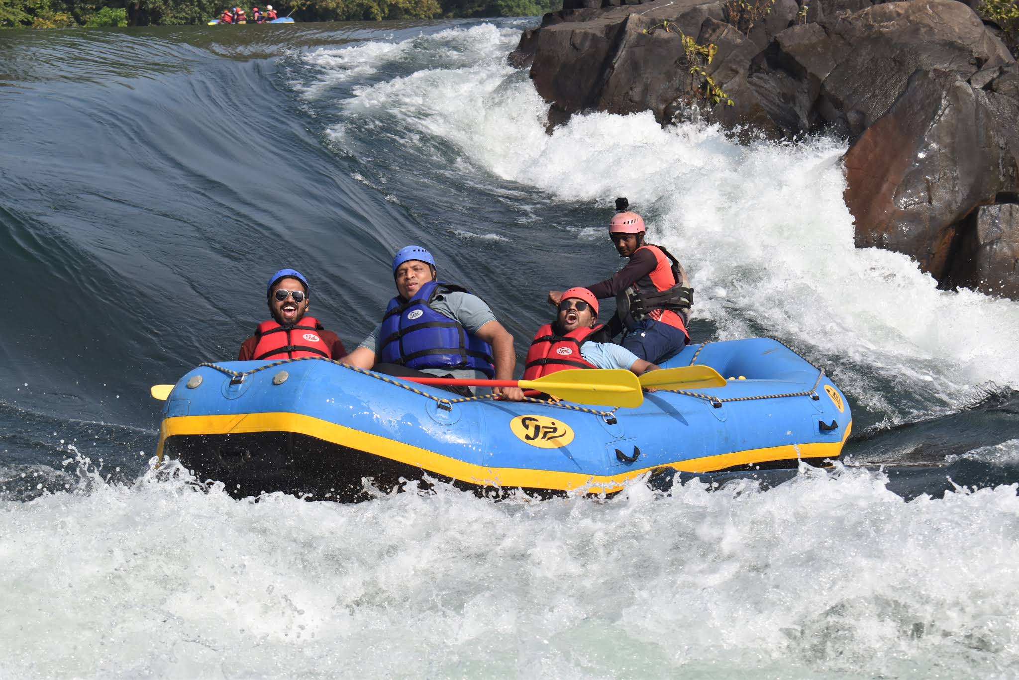 Action shot of tourists enjoying white water rafting on the Kali River in Dandeli.
